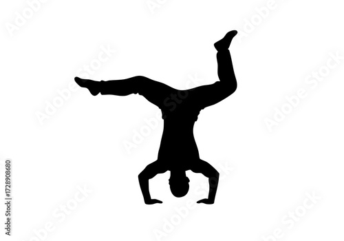 Silhouette of a person performing a handstand, showcasing balance and strength.