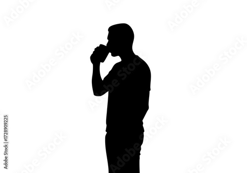 A silhouette of a person drinking from a can.
