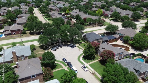 Residential cul-de-sac dead-end in Coppell, Texas, featuring two-story suburban homes, fenced yards, swimming pools, tree-lined streets leading toward Cottonwood Creek Elementary School campus