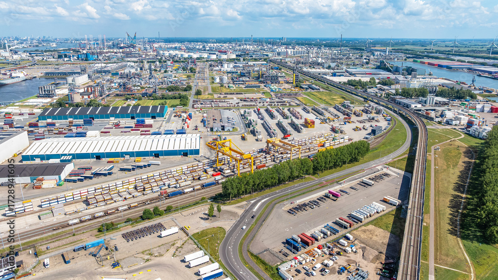 Fototapeta premium Drone view Rotterdam city with river on cloudy horizon. Industrial area of ​​Rotterdam, Netherlands