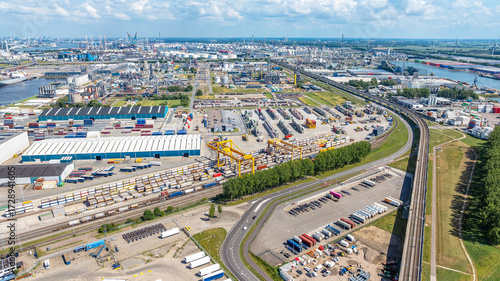 Drone view Rotterdam city with river on cloudy horizon. Industrial area of ​​Rotterdam, Netherlands