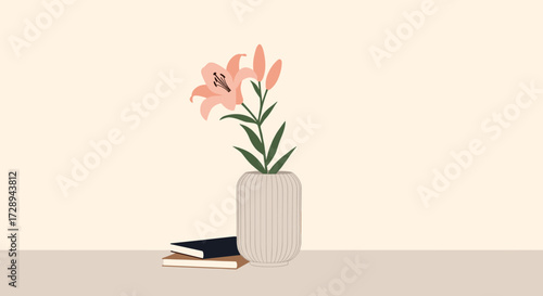 A delicate pink lily stands tall in a textured vase beside a stack of books and a notebook on a neutral surface.
