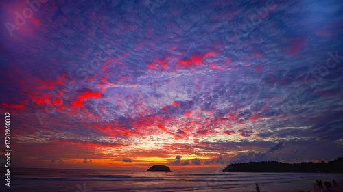 Time lapse Island Glow at Kata Beach Phuket. The last rays of sunshine illuminate the clouds with vibrant colors, blending seamlessly with the turquoise waters, a perfect moment of peace and wonder.