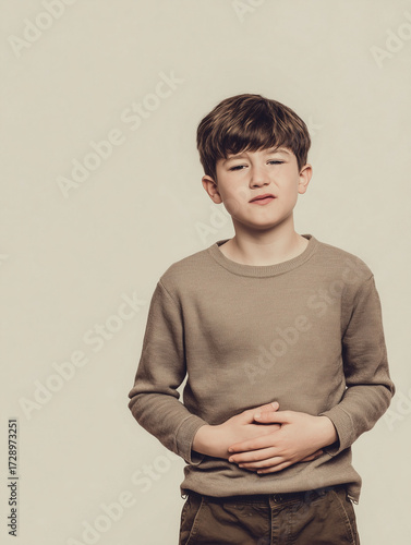 Japanese Child 6 years old holding stomach in discomfort