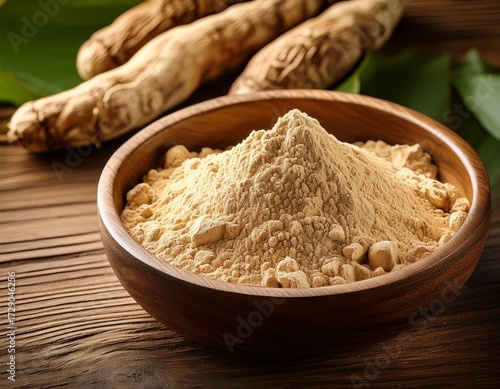 maca root powder in a wooden bowl with fresh maca roots on a wooden background