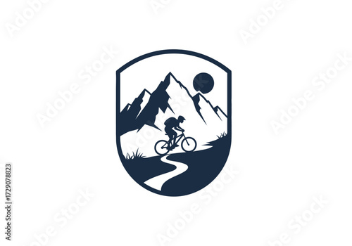Mountain biker riding a trail in front of mountains and sun in a shield.