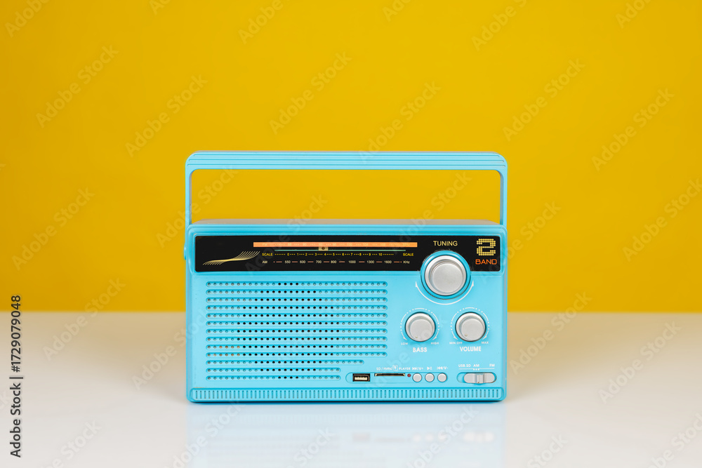 Fototapeta premium Front view of old radio receiver light blue color on white table isolated on yellow background with copy space.