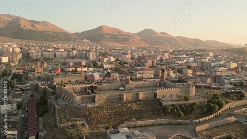 Erzurum, Turkey - 20th august, 2025: Aerial Erzurum Castle and citadel, stone ramparts and clock-tower minaret above city golden hour; Byzantine 5th–6th c.origins with Seljuk - Ottoman restorations