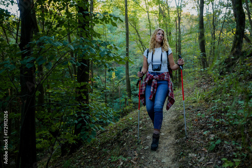 Wallpaper Mural Woman hiking forest trail using trekking poles Torontodigital.ca