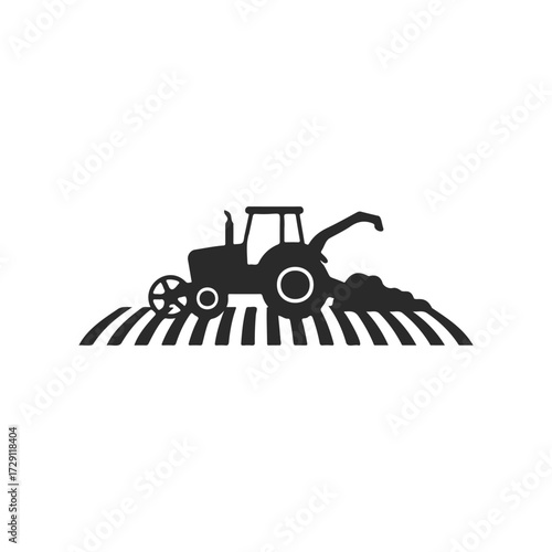 Black silhouette of tractor harvesting crops in field
