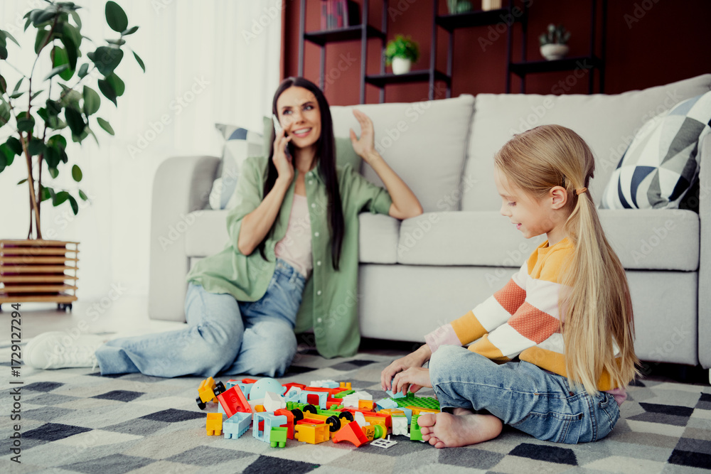 Obraz premium Mother and daughter playing together with colorful toys in living room enjoying shared moments and bonding time