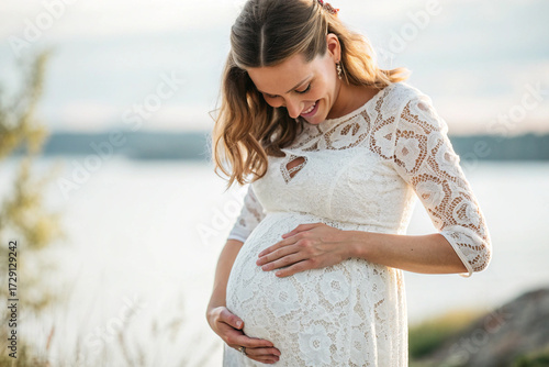 pregnant woman gently holding her belly, side angle view, natural light, soft focus, maternity concept