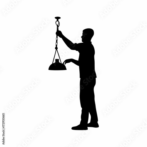 Silhouette of caretaker tending to chicks under a heating lamp isolated on white background