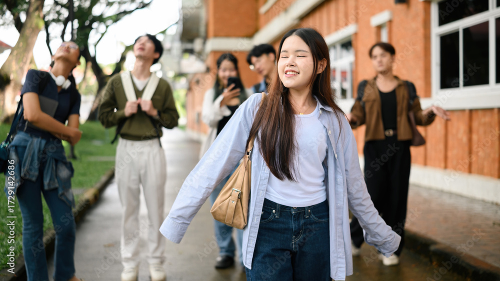 Obraz premium A Carefree university student woman smiling and enjoying freedom outdoors, representing youth, independence, and a positive mindset in education