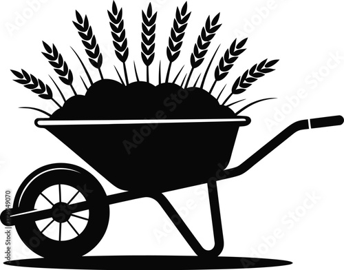Black wheelbarrow with wheat stalks agriculture harvest