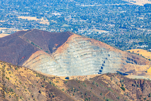 View from Mount Tamalpais East Peak in Marin County, California, overlooking a terraced quarry and the Bay Area cityscape, contrasting natural hills with industrial landscape