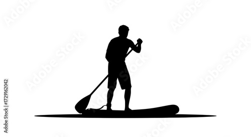 Active man silhouetted on paddleboard enjoying water sport adventure under clear sky