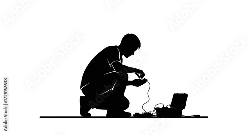 Focused technician meticulously assembling electronic device with portable equipment nearby
