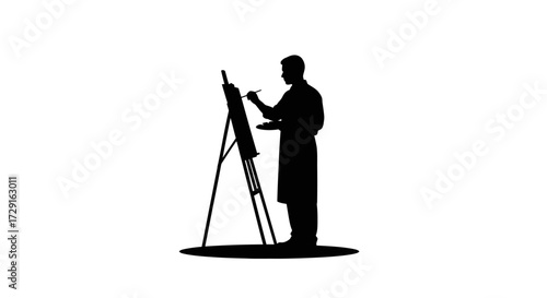 Artist silhouette creating masterpiece on easel with palette and brush, focused concentration