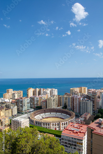 Panoramic view of coastal city with bullring and sea