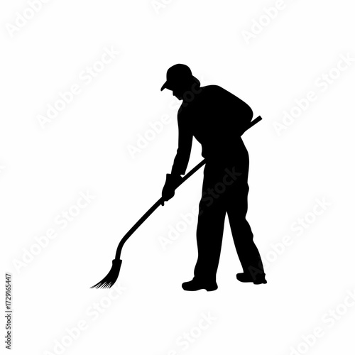 Silhouette of a farmer removing old straw bedding from an animal enclosure isolated on white background
