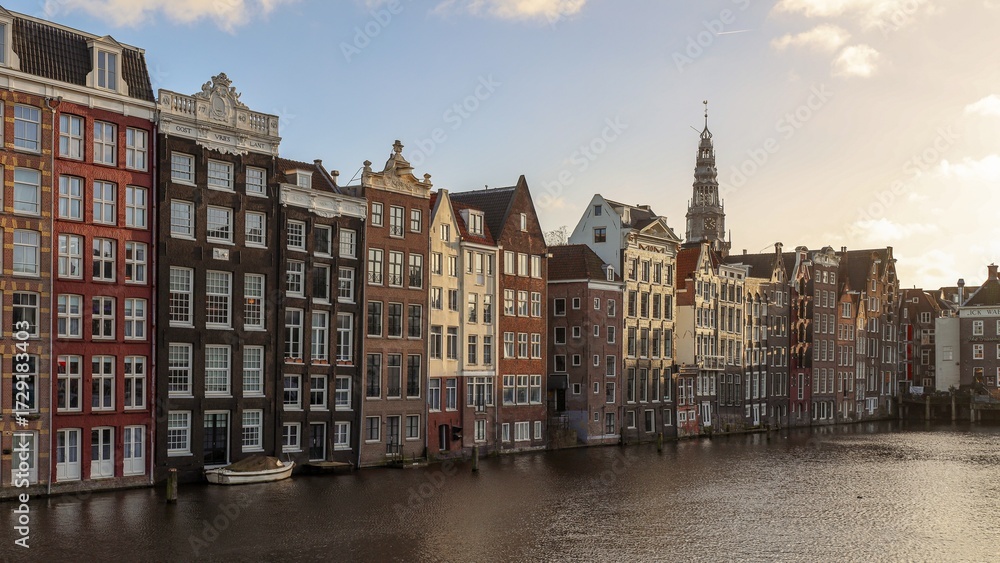 Fototapeta premium Historic Canal Houses Along the Water in Amsterdam at Sunset