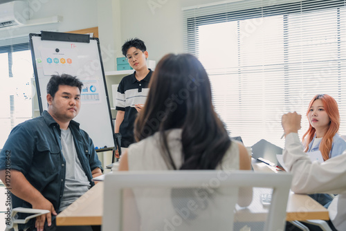 Female executive leads strategic brainstorming session using flipchart methodology, facilitating cross-functional ideation with business partners through data-driven innovation and agile frameworks