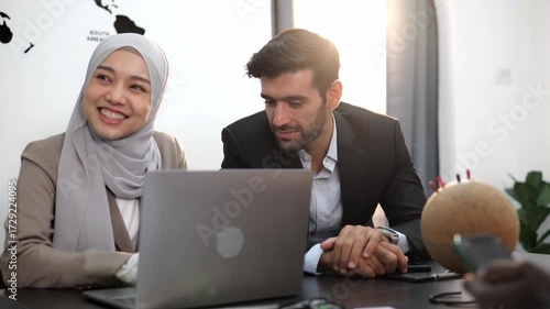 4k video slow motion Two happy business people, businessman and young beauty Muslim women using a laptop while sitting and discussing details and presenting business information in conference room.