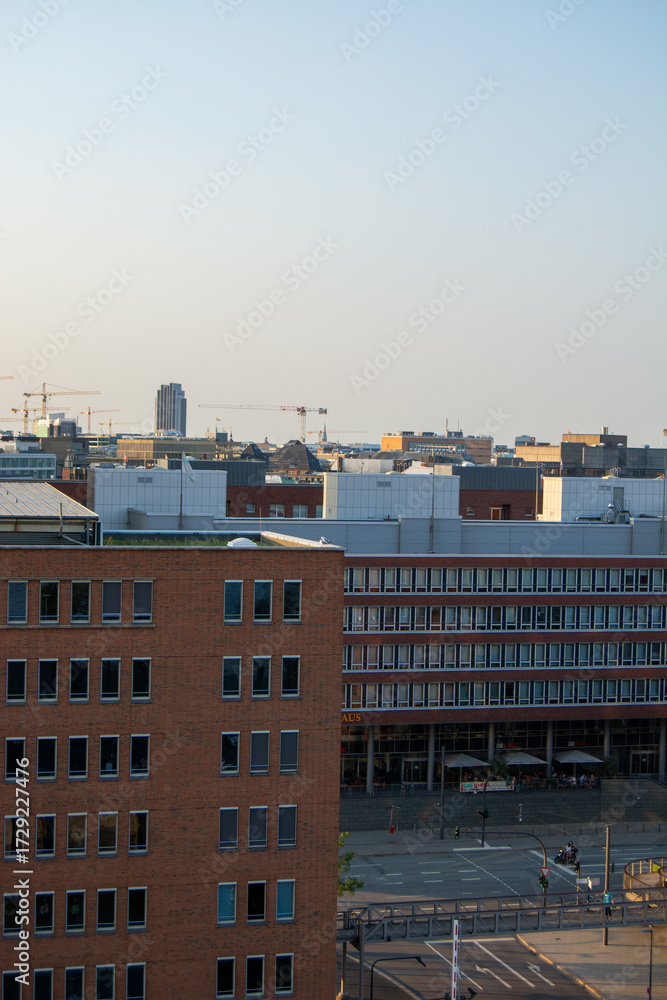 Fototapeta premium Urban cityscape with construction cranes and modern buildings