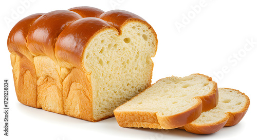Freshly baked French brioche loaf, golden and glossy, sliced to show airy texture, isolated on white