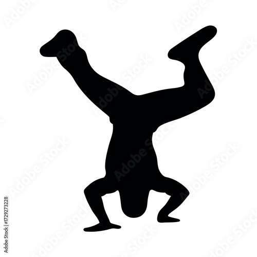 Silhouette of a person performing a dynamic handstand with legs extended in a dance move