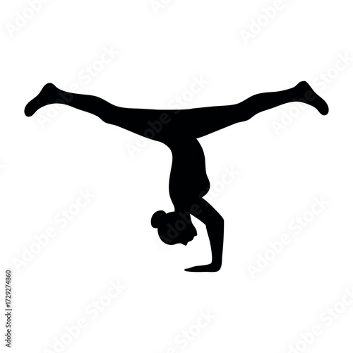 Silhouette of a woman performing a challenging handstand with legs spread wide in a dynamic pose