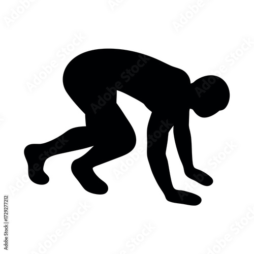 Silhouette of a person in a low crouch ready to spring forward in a race or athletic movement