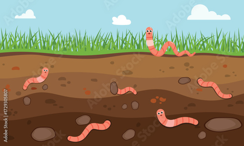 Cute earthworms in the soil under green grass, showing underground life, nature, and the importance of worms in the garden ecosystem. vector illustration of earthworm in garden