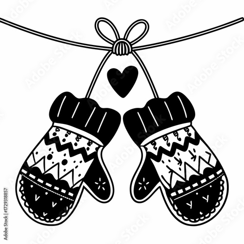 Knitted mittens hanging with heart decoration on string  