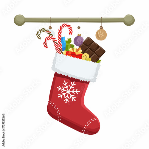 A Christmas stocking stuffed with candy canes, chocolates, and mini boxes hanging from a mantelpiece.