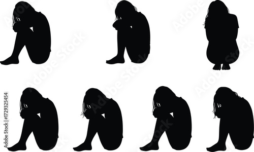 Black silhouette figures of people sitting on ground with knees drawn up, head resting, expressing sadness, depression, loneliness, contemplation