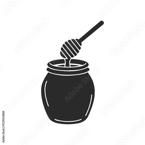 Silhouette of honey dipper in jar on white background
