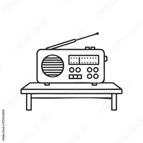Vintage radio on table with antenna and dial controls