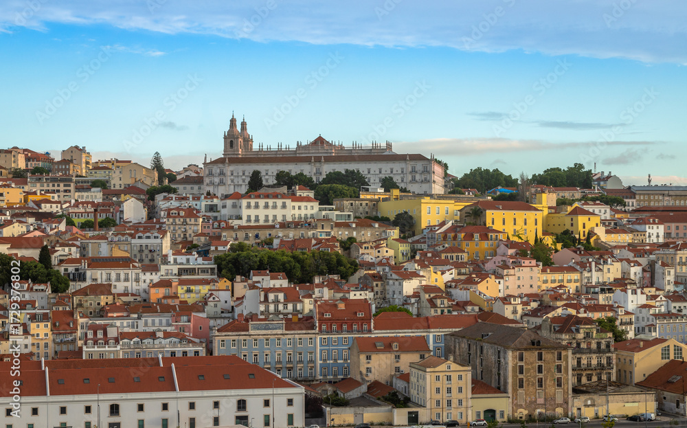 Fototapeta premium Panoramic Exposure done from a Cruise ship in the Cruise Ship terminal in Lisbon, of the Alfama neighborhood upon departure on the tagus river, Portugal