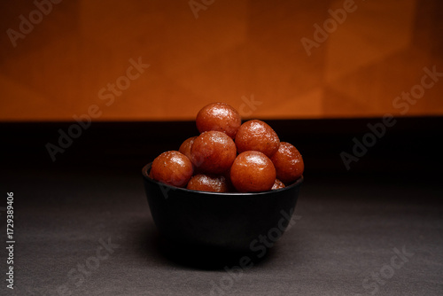 A bowl full of gulab jamun in sugar syrup pool, luxury dessert
