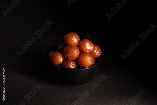A bowl full of gulab jamun in sugar syrup pool, luxury dessert