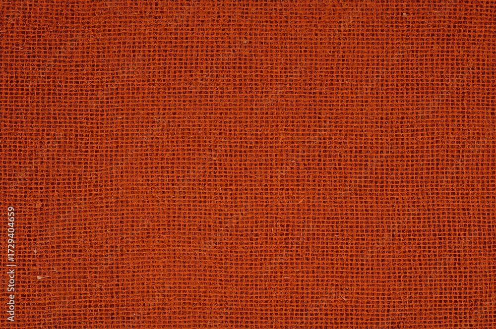 Fototapeta premium Close-up of dark orange fabric texture, detailed macro view.