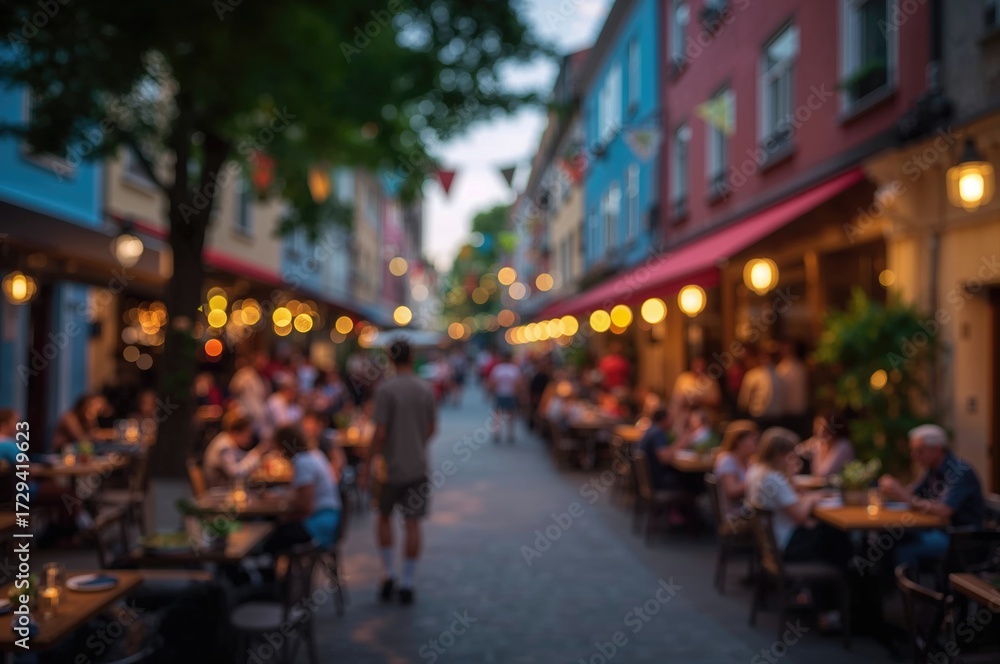 Obraz premium Blurred backdrop of lively alfresco dining on a stone-paved lane with vivid structures and soft illumination. Out-of-focus photo for background use.