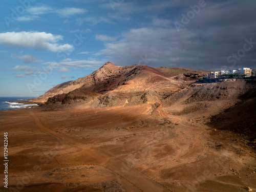The arid volcanic landscape of La Isleta peninsula in Las Palmas de Gran Canaria, Spain
