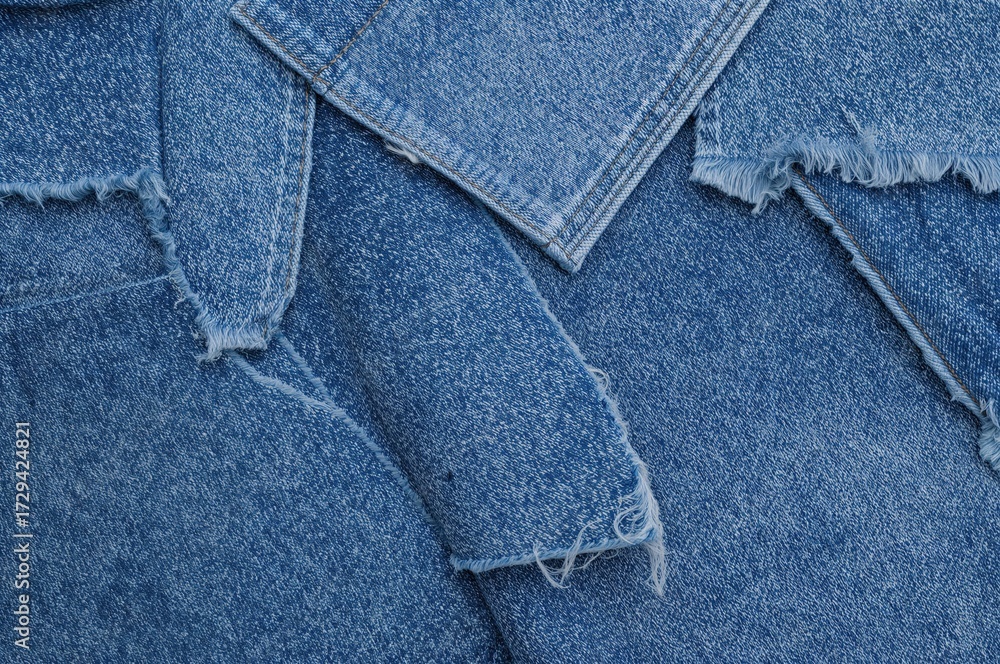 Fototapeta premium Samples of distressed denim fabric in blue hues. Torn and ripped denim textile pieces, banner backdrop. Repurpose worn denim material. Various denim cloth fragments.