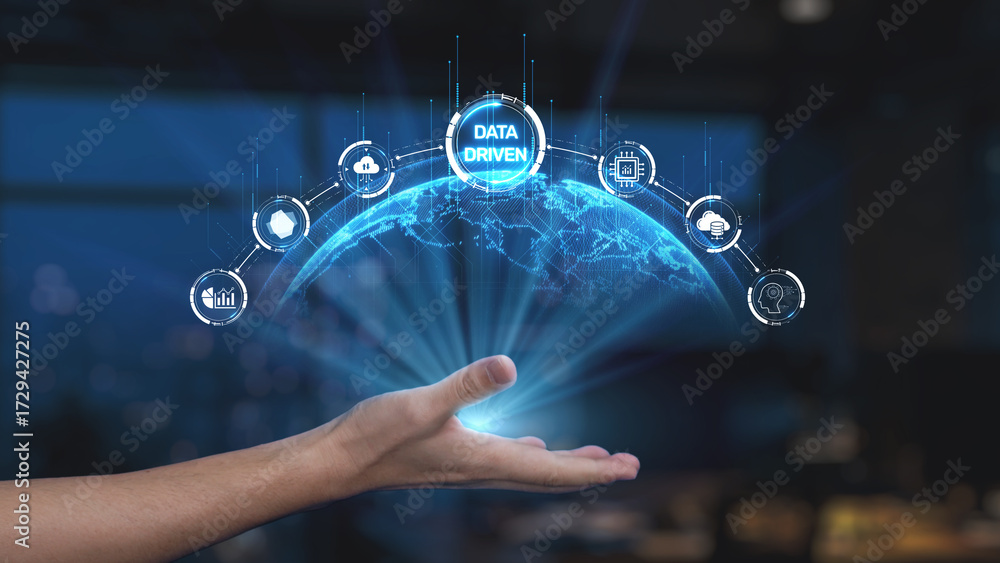Fototapeta premium A hand is reaching out towards a glowing globe, illustrating a digital network of icons that symbolize data analytics and technological advancement in a modern workspace. Synapse