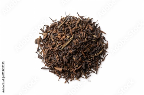Close-up of a pile of Assam tea leaves on a white backdrop