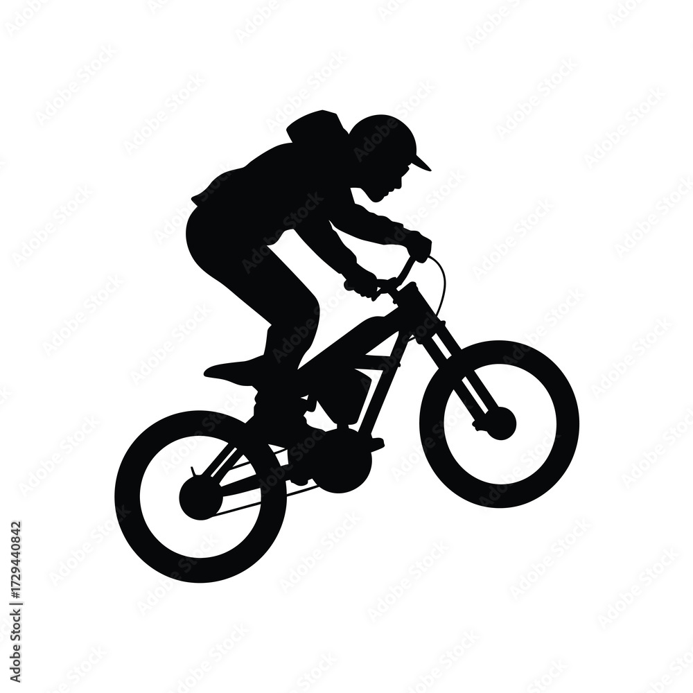 Fototapeta premium Dynamic silhouette of a motocross rider performing a wheelie on a bicycle