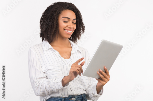 Wallpaper Mural Checking Mail. Black millennial girl using tablet, browsing internet isolated on white studio background, copyspace Torontodigital.ca